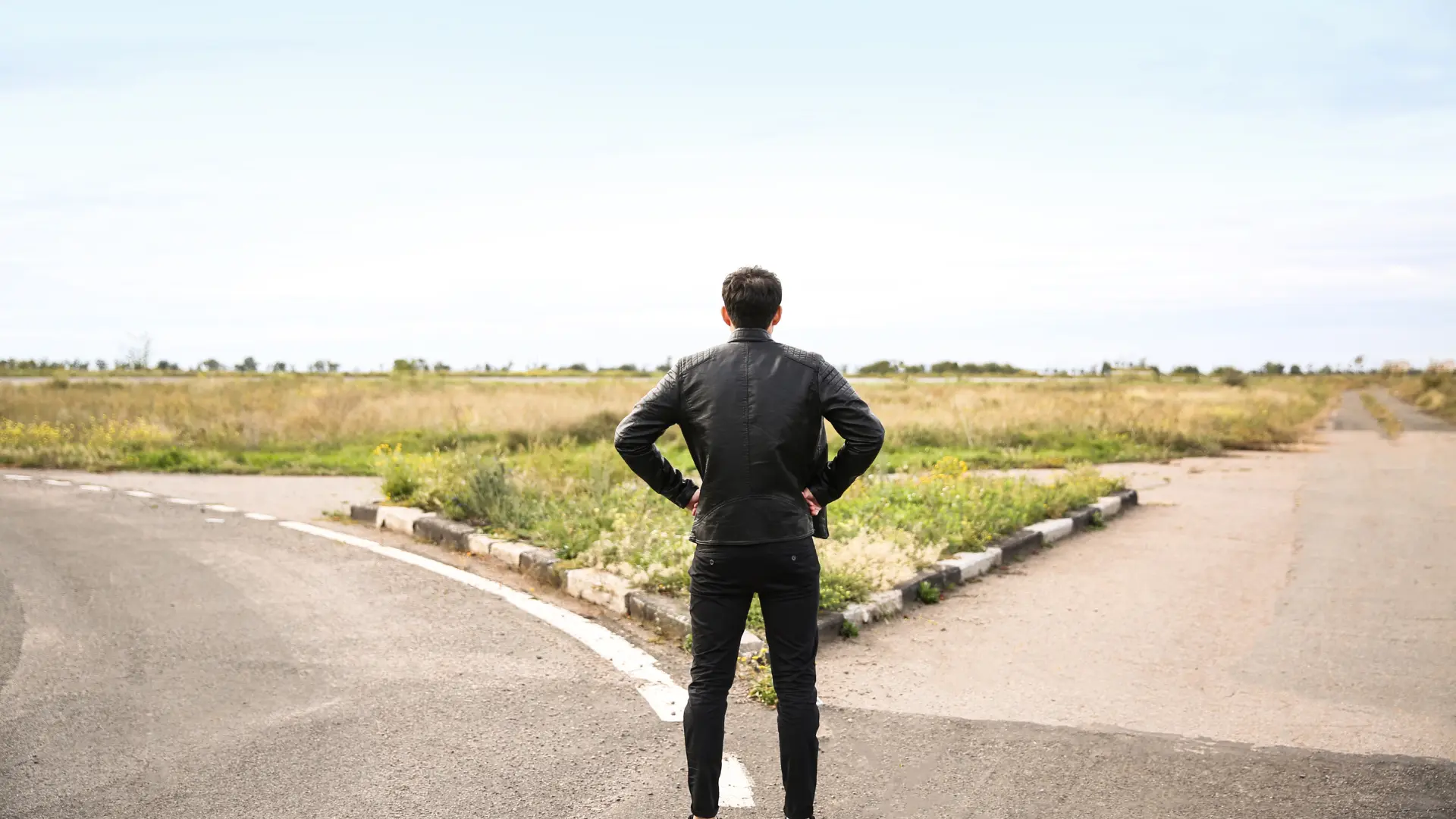 Un homme face à une route qui se sépare en deux.